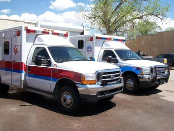 Two a ambulances parked outside of the Penrose Volunteer Fire Department Station 2.